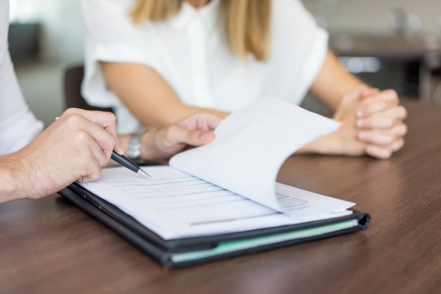 hands-male-executive-showing-contract-female-partner-meeting
